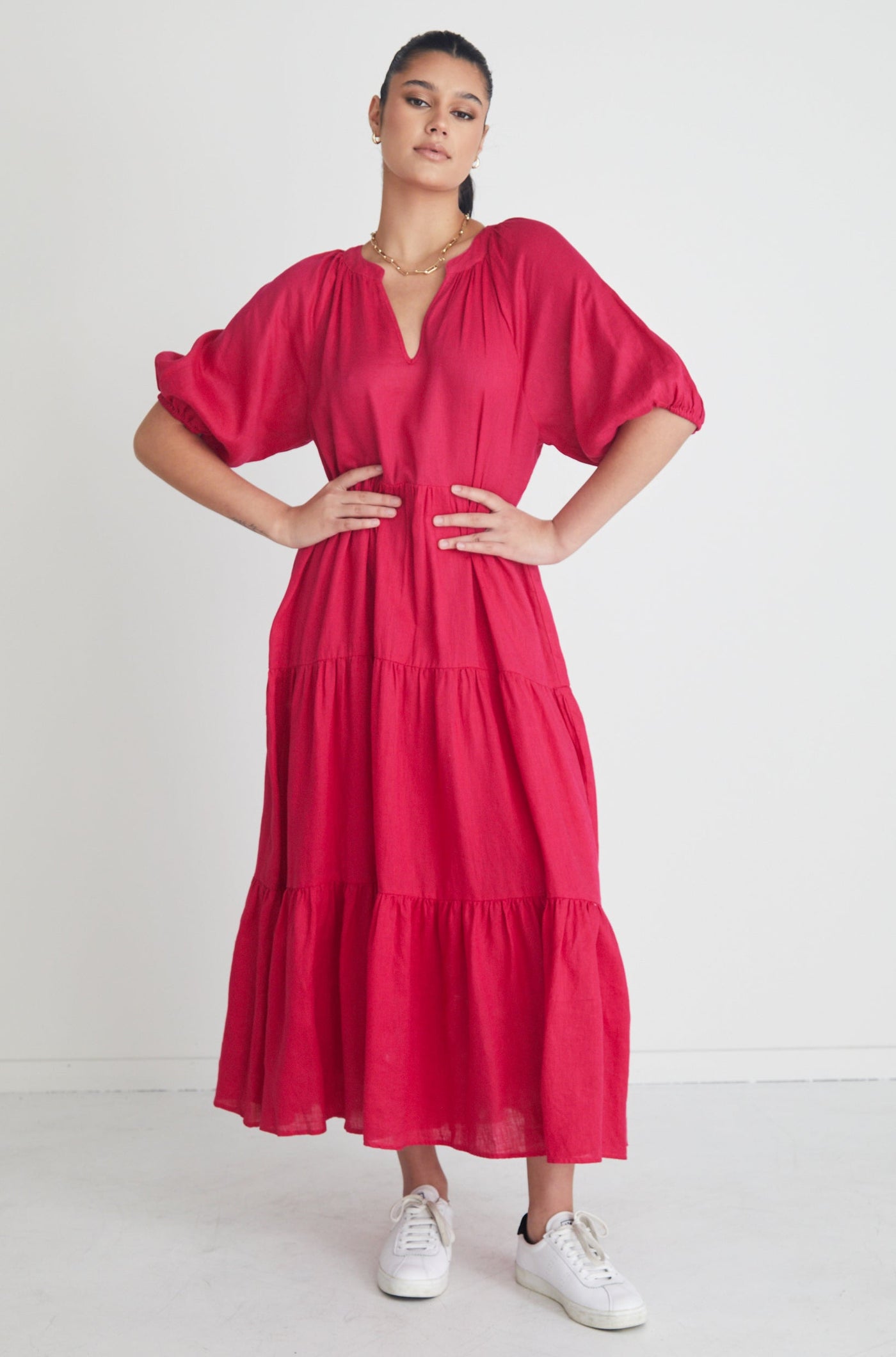 The Santorini Maxi Dress available in a beautiful bright Rasberry! Stay stylish yet comfortable all day in this eyecatching maxi! Maxi length Puff sleeve V neckline Tiered skirt 100% Linen