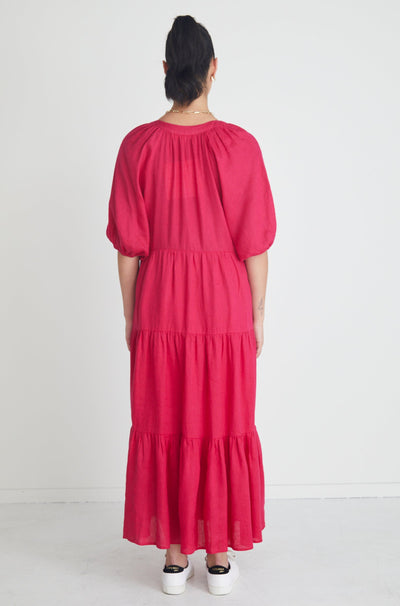 The Santorini Maxi Dress available in a beautiful bright Rasberry! Stay stylish yet comfortable all day in this eyecatching maxi! Maxi length Puff sleeve V neckline Tiered skirt 100% Linen