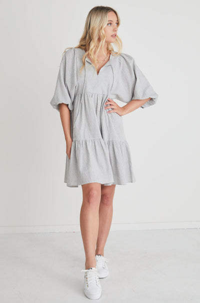 This shape is a must this season! The Provocation Dress features puff sleeves, a tiered design, and tie-up detail, what's not to love?      Mini Length     Puff Sleeve     Tie-up detail     90% Cotton, 10% Linen