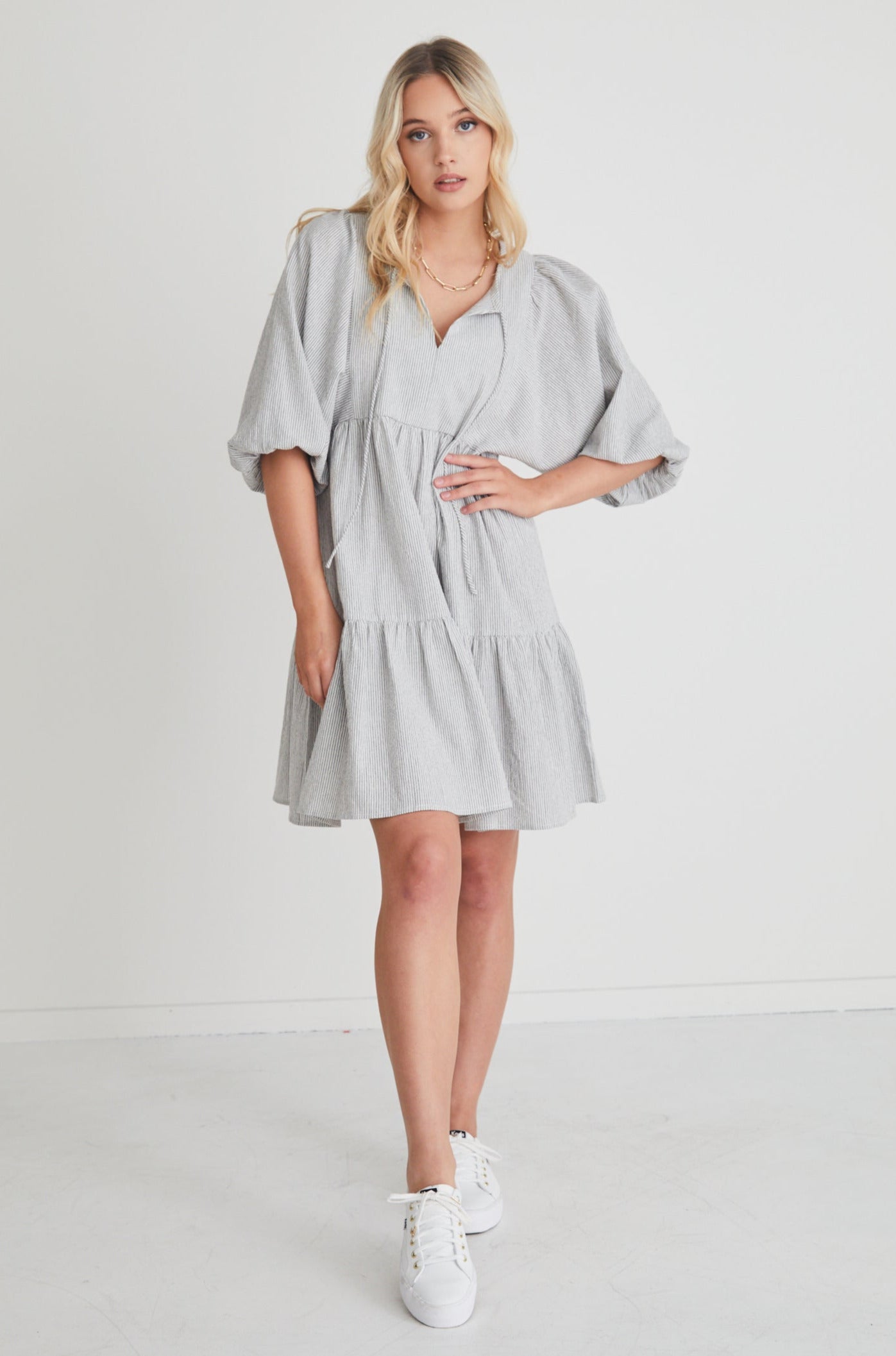 This shape is a must this season! The Provocation Dress features puff sleeves, a tiered design, and tie-up detail, what's not to love?      Mini Length     Puff Sleeve     Tie-up detail     90% Cotton, 10% Linen