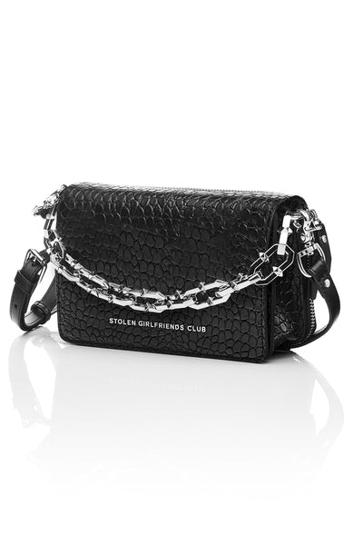 The Stolen Girlfriends Club Little Trouble Bag is an edgy crossbody bag, now available in Matte Black.  Crafted in 100% genuine leather and features a funky crocodile texture throughout.  The Little Trouble Bag opens via a magnetic flap, and features a metal 'Stolen Girlfriends Club' plaque at the front, internal card slots, two internal zipper pockets, and comes with plain self and optional chunky chain straps.