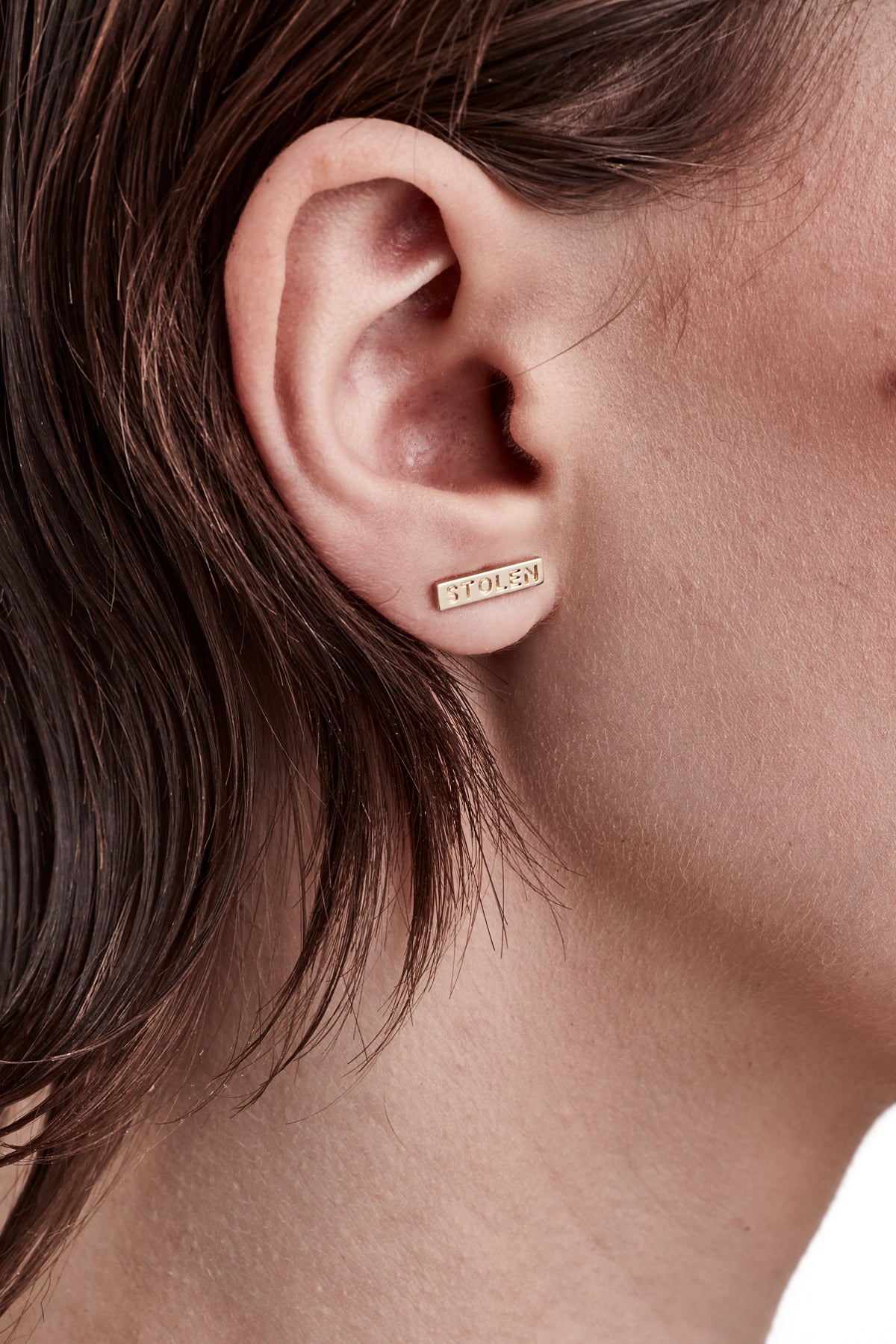   STOLEN GIRLFRIENDS CLUB TINY STOLEN BAR EARRINGS  The Stolen Girlfriends Club Stolen Bar Earrings are the perfect gift for a Stolen fan. They are a stud earring with a 1.3cm gold plated bar featuring the words "STOLEN" engraved on each.       Engraved "STOLEN"     18k Gold plated     Sold as a pair 