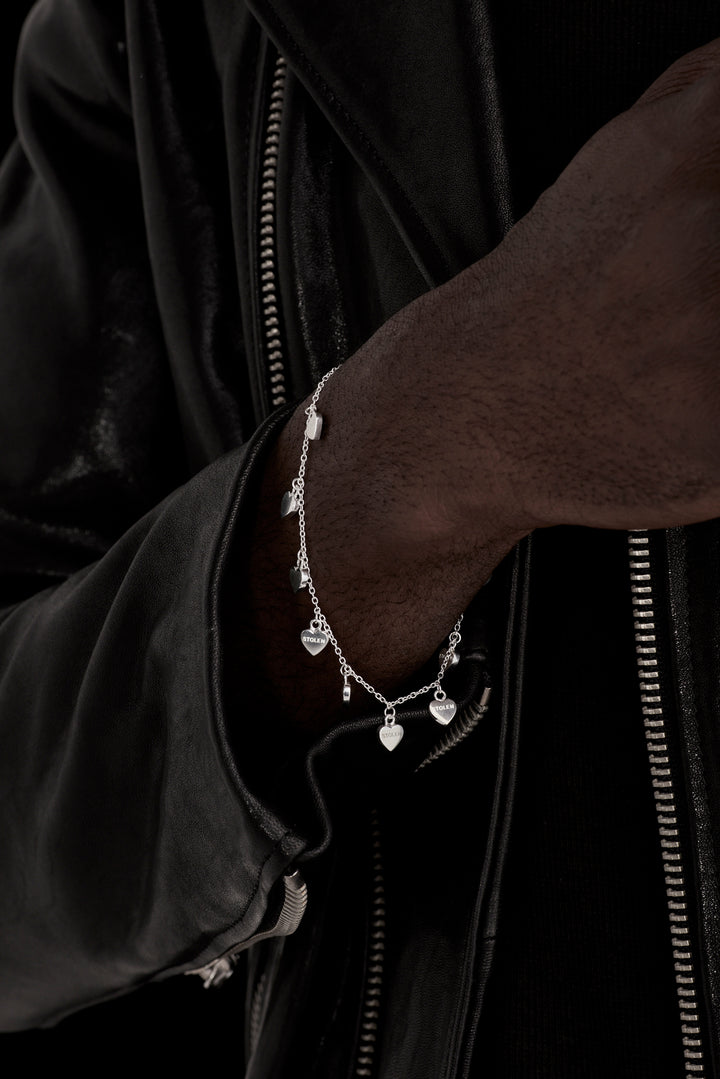 STOLEN GIRLFRIENDS CLUB STOLEN HEART BRACELET  The Stolen Girlfriends Club Stolen Heart Bracelet is a delicate bracelet featuring eight mini hearts, all connected to the fine chain in a hanging charm style, closing with a thick clasp. Layer with other Stolen bracelets, or alone for some simple sophistication.      19cm chain length      High polished sterling silver     Comes in a Stolen Girlfriends Club jewellery box