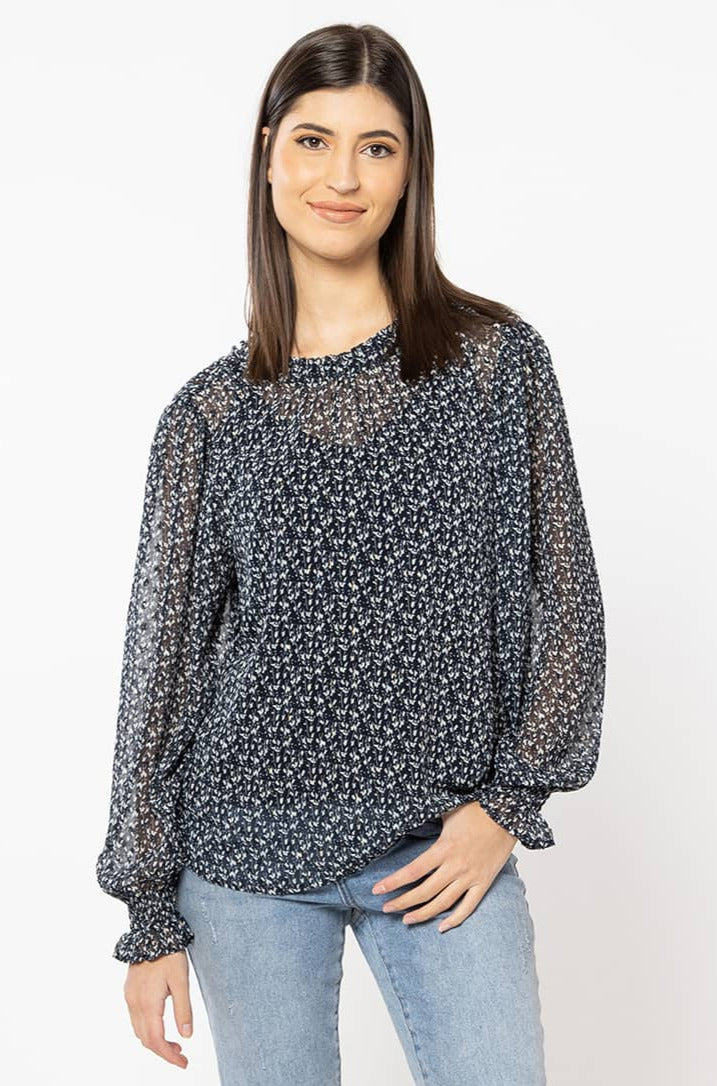 The Billie The Label Alia Top has a luxe feel. It is a navy base finished with a soft cream floral and gold lurex throughout. The Aila top has lovely shirred cuffs and a sweet neckline. Team back with black bottoms for a classic look.  100% polyester  Sizes 8,10,12,14 Shirred cuff sleeves Lurex throughout