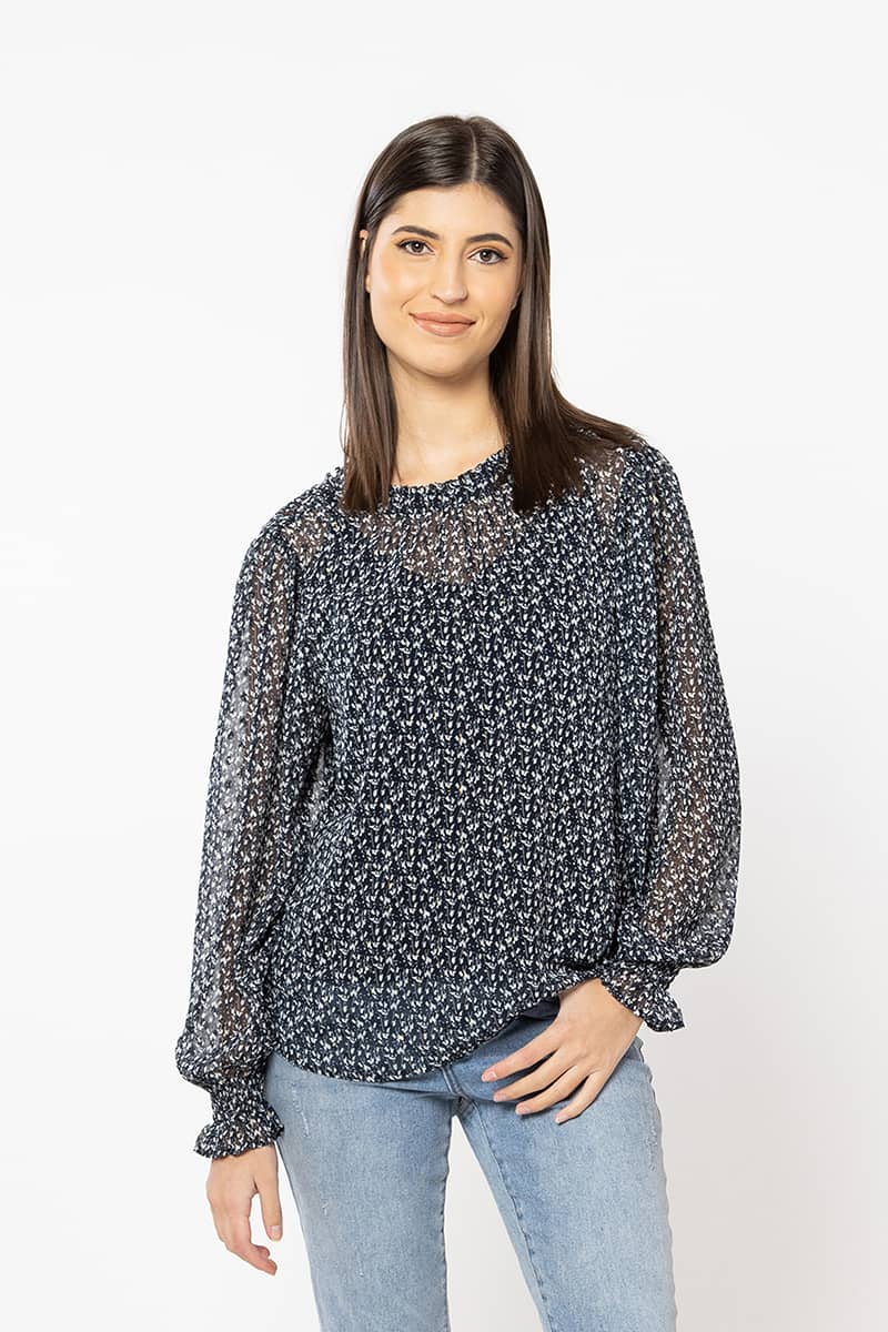 The Billie The Label Alia Top has a luxe feel. It is a navy base finished with a soft cream floral and gold lurex throughout. The Aila top has lovely shirred cuffs and a sweet neckline. Team back with black bottoms for a classic look.  100% polyester  Sizes 8,10,12,14 Shirred cuff sleeves Lurex throughout