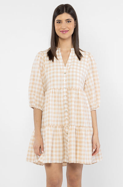 The Billie The Label Truthful Mini Dress is available in camel check. It features a v neck line, 3 tiers, a buttoned down front and is lined. Team back with sandals or trainers for summer for a cute fit.   Lined  Button closure  V neckline 100% Polyester 