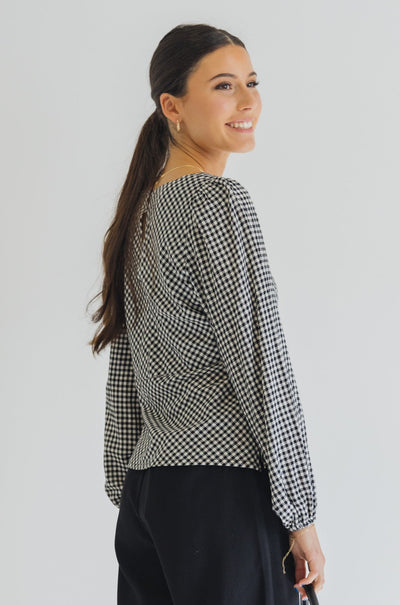 Among The Brave Bailey Bias Balloon Sleeve Top - Black Gingham  The Bailey top from Among the Brave is an elegant staple you need in your wardrobe. It features long balloon sleeves and is a bias cut. Available in a black and white gingham this top will elevate any look, We love how this top styles with black dress pants, heels and a blazer.      Long balloon sleeves     Panel bodice     Bias cut     Lined