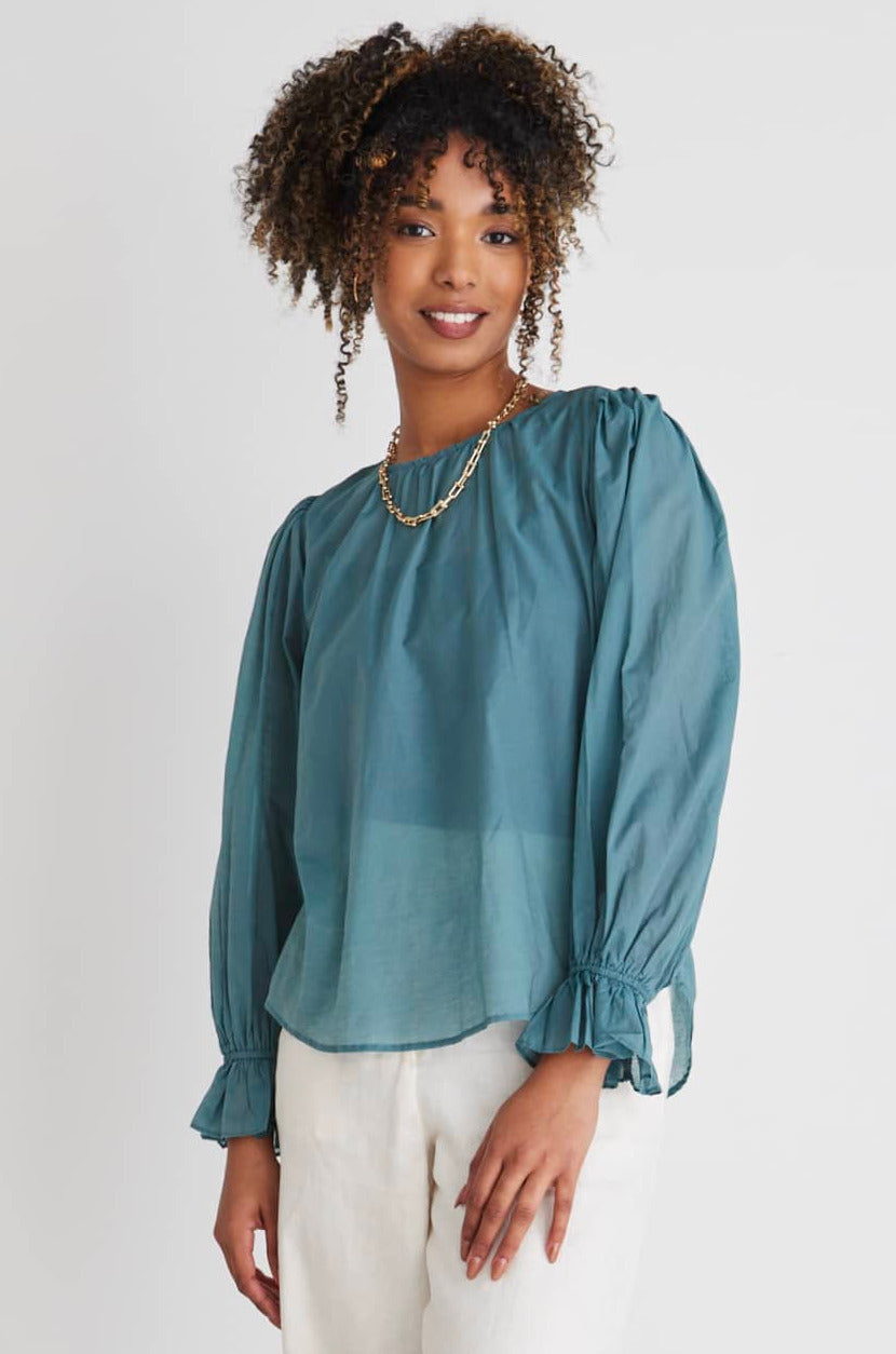 Introducing the Candid Top from By Rosa, a versatile addition to your wardrobe. This stunning lightweight blouse is designed to effortlessly transition you from the office to after-work drinks, making it a must-have for the modern woman on the go.      Long sleeve     Frill elastic sleeves     Ruched shoulders     Rounded neckline     70% cotton 30% tencel
