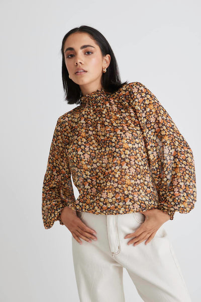 The Embrace High Neck Shirred Top has to be one of our top picks. Now available in this gorgeous black spice floral, you are sure to turn heads. It features a shirred high neck and it finished with matching shirred cuffs. An easy throw-on and go style taking you from day to night.   High neck  Shirring detail Floral print 100% Polyester