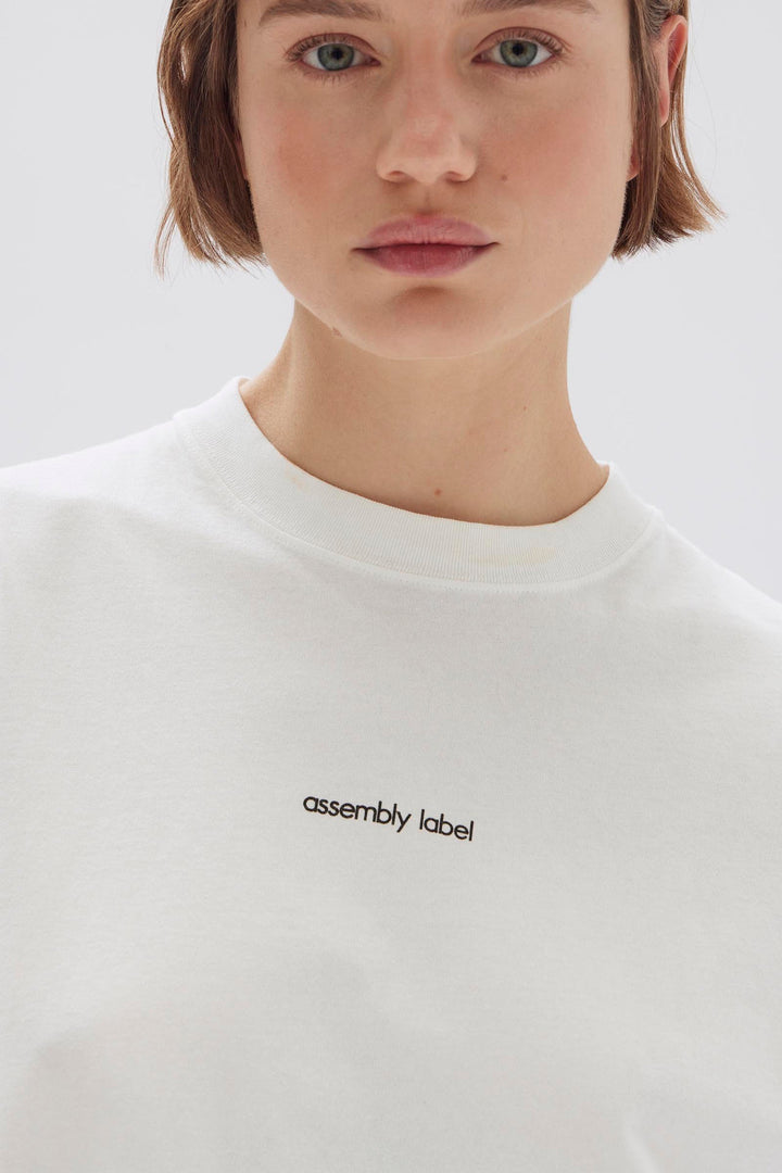 Assembly Label Exhibited Print Short Sleeve Tee | Antique White & Black