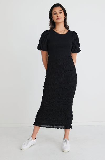The Jade Black Dress by Ivy + Jack is here to be your forever favourite! Featuring an elegant and flattering ruched body, and gorgeous puff sleeves that create a stunning silhouette, this dress won't let you down. Pair with some little black heels for an evening look or white sneakers and a crossbody bag for daytime styling.       Ruched Bodycon     Puff sleeves      Round neckline     Stretch Material      Midi length 