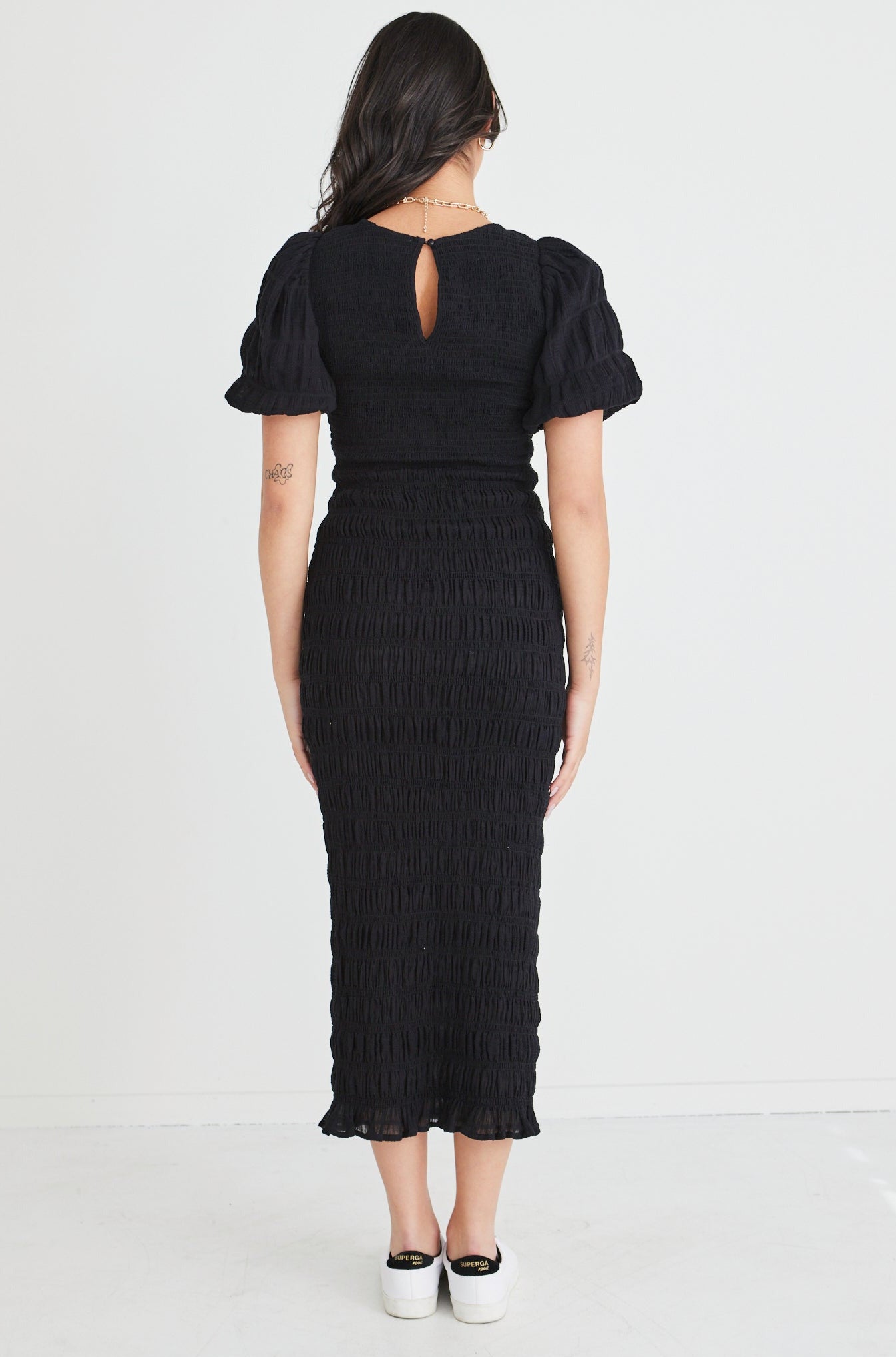 The Jade Black Dress by Ivy + Jack is here to be your forever favourite! Featuring an elegant and flattering ruched body, and gorgeous puff sleeves that create a stunning silhouette, this dress won't let you down. Pair with some little black heels for an evening look or white sneakers and a crossbody bag for daytime styling.       Ruched Bodycon     Puff sleeves      Round neckline     Stretch Material      Midi length 
