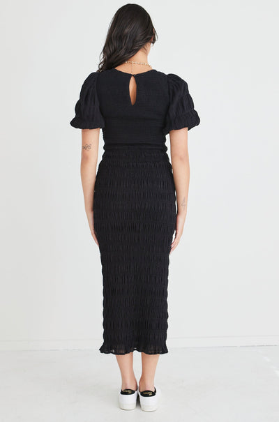 The Jade Black Dress by Ivy + Jack is here to be your forever favourite! Featuring an elegant and flattering ruched body, and gorgeous puff sleeves that create a stunning silhouette, this dress won't let you down. Pair with some little black heels for an evening look or white sneakers and a crossbody bag for daytime styling.       Ruched Bodycon     Puff sleeves      Round neckline     Stretch Material      Midi length 