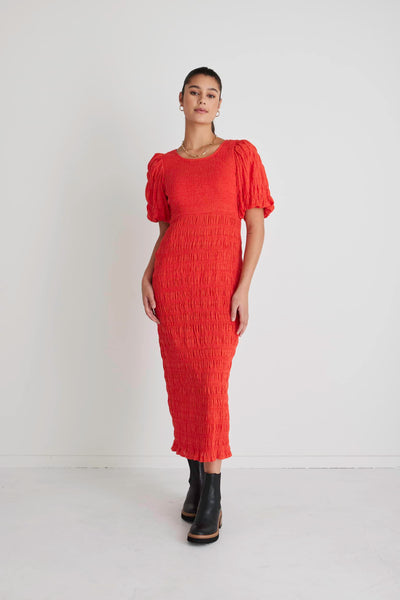 The Jade Blood Orange dress by Ivy + Jack will be sure to turn heads! Featuring an elegant and flattering ruched bodycon, this dress will shape you in all the right places while also feeling snug and stylish. Pair the dress with some little black boots for a day-to-evening look or some white ankle sneakers for casual daytime styling.  Ruched Bodycon Puff sleeves  Round neckline Stretch Material  Midi length 