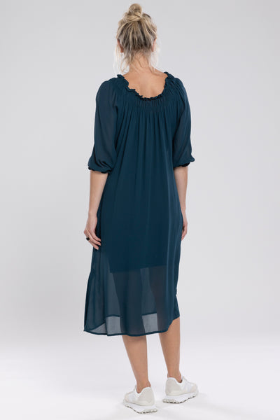 The Merchant Dress is a new style. Great dress to dress up or down. An off the shoulder design with the option to wear up. It features a shirred neckline which creates a relaxed drape through the body. Side Seam Pockets & a waist belt can be worn ties or left untied.      Length finishes below the knee.     A feminine and fun piece!     Viscose