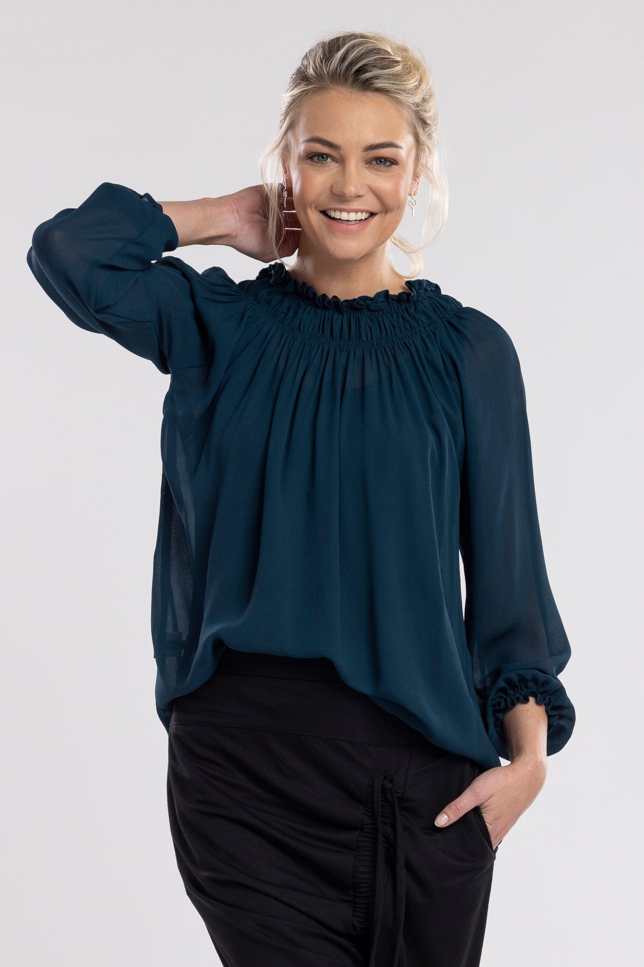 An off the shoulder design with the option to wear up, features a shirred neckline which creates a relaxed drape through the body.  A feminine and fun piece!       Viscose     Shirred neckline     Cuff sleeves 