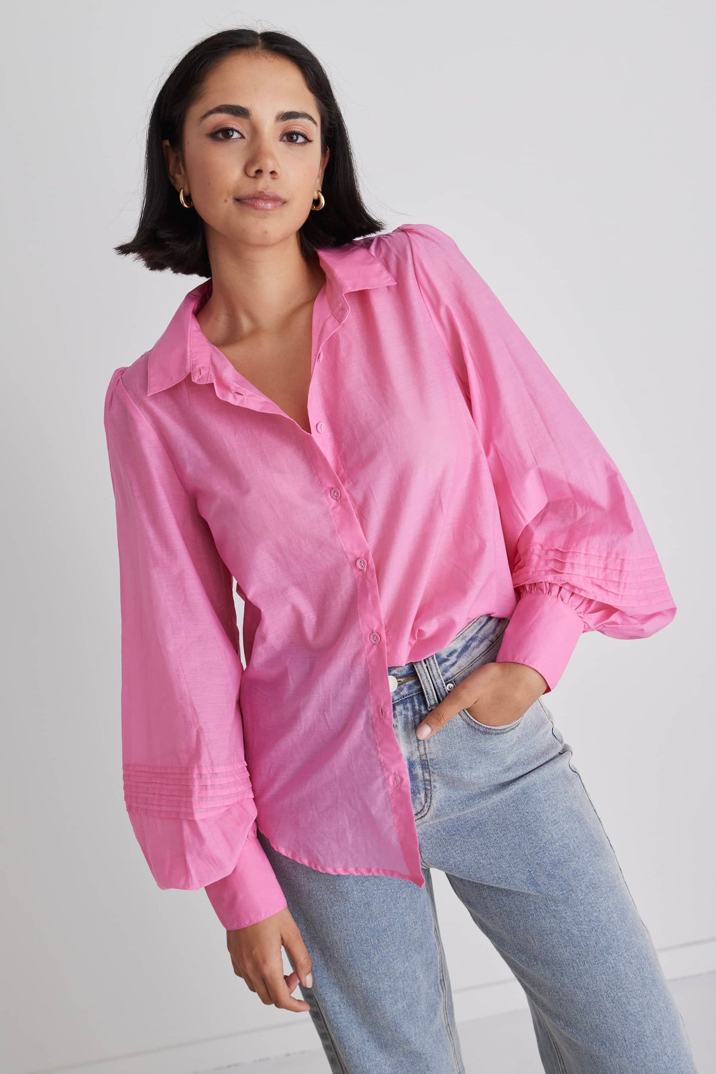 Stories Be Told Savvy Sheer Puff Sleeve Shirt - Bubblegum Pink The Stories Be Told Savvy Shirt, a captivating and bold addition to your wardrobe. This shirt combines the delicate allure of sheer fabric with a vibrant bubblegum pink color, creating a striking and eye-catching ensemble. Team with black, white or denim bottoms for an simple outfit.      Button up front       Puff Sleeve       Button Cuffs      Slightly Sheer     30% Tencel, 70% Cotton