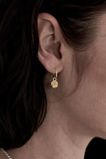 STOLEN GIRLFRIENDS CLUB ROSE BUD ANCHOR SLEEPER  The Stolen Girlfriends Rose Bud Anchor Sleeper are gorgeous half hoop stud-style earrings, each suspending cute mini rose bud charms.  Crafted using gold plating, these little stars are great for every day wear.      Half hoop stud-style earrings