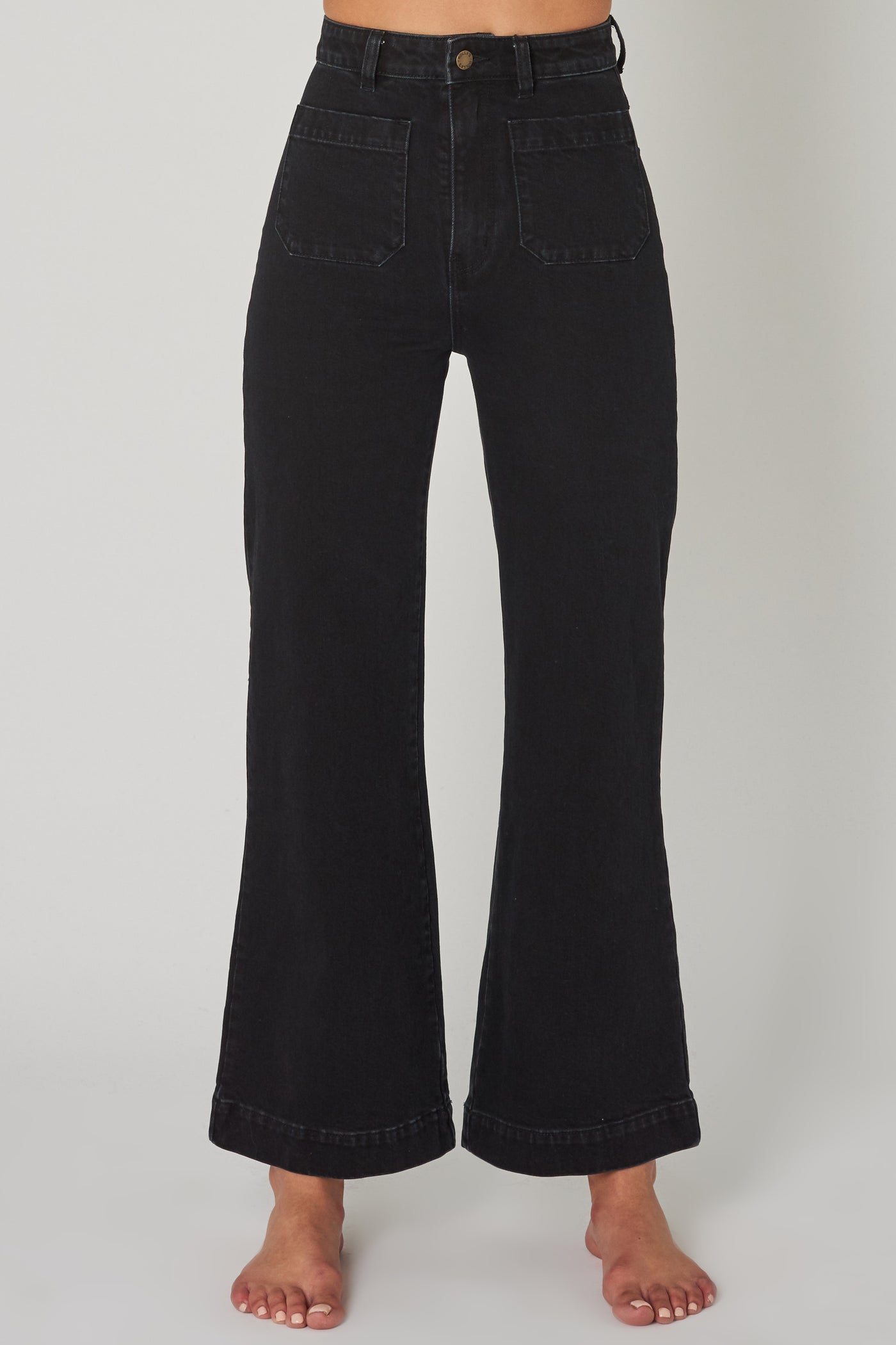 ROLLAS WOMENS SAILOR JEAN - COMFORT JET BLACK  The Rollas Sailor Jeans are now available in Comfort Jet Black, and are a stylish modernised take on classic flares. The Sailor Jeans have a high-waist, and feature a classic zip-to-button closure, with two functional 'sailor style' pockets at the front, and classic signature Rollas branded pockets at the back, finished with wide flared legs. Simple, stylish and easy to wear, team the Rollas Sailor Jeans back with any of your favourite tops this season.