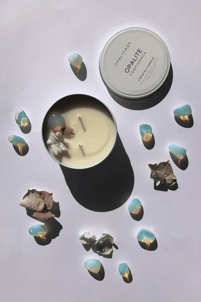 OPAL + SAGE MEDIUM CANDLE   The Opal + Sage Medium Candles make fantastic gifts, and add a subtle scent to any room. These candles are the big-sister candles to The Opal + Sage Candles.  Each Candle has two wicks, and is housed in a metal reusable tin. Each Medium Candle holds a unique crystal or stone, no two are the same. Your crystal/stone will be fully revealed as your candle burns.