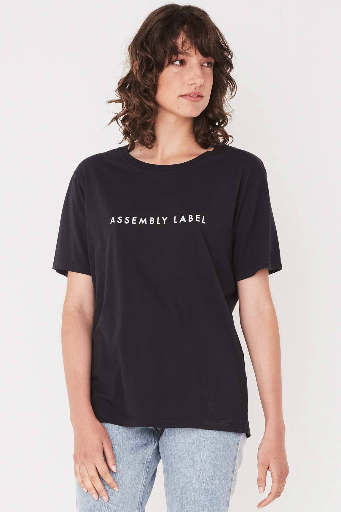 ASSEMBLY LABEL LOGO COTTON CREW TEE  The Assembly Label Logo Cotton Crew Tee is a classic slogan tee perfect for every day wear. The Logo Cotton Crew is the t-shirt version of the cult favourite Assembly Label Logo Fleece  The Assembly Label Logo Cotton Crew Tee features a relaxed silhouette and crew neckline, finishing with signature 'Assembly Label' screen print across the chest. 