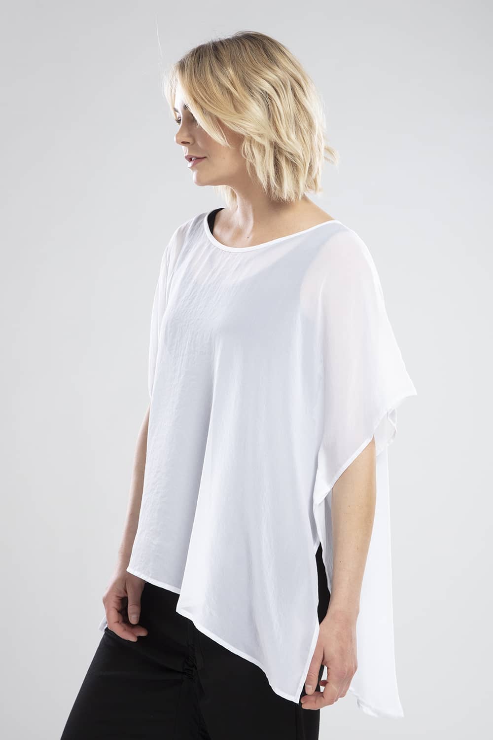 NES CIVITA TOP  The Nes Civita Top is a sheer staple for everyday wear. Crafted from 100% polyester, this easy to wear top is loose and flowing, with angled sleeves and a slight drop tail, featuring a split detail on the left side, ideal for tying up or tucking in.   See the Nes Civita Top teamed back with the Nes Roxi Pant in black  Sizes S/M , M/L 100% Polyester Angled sleeves Slight drop tail Left side split detail