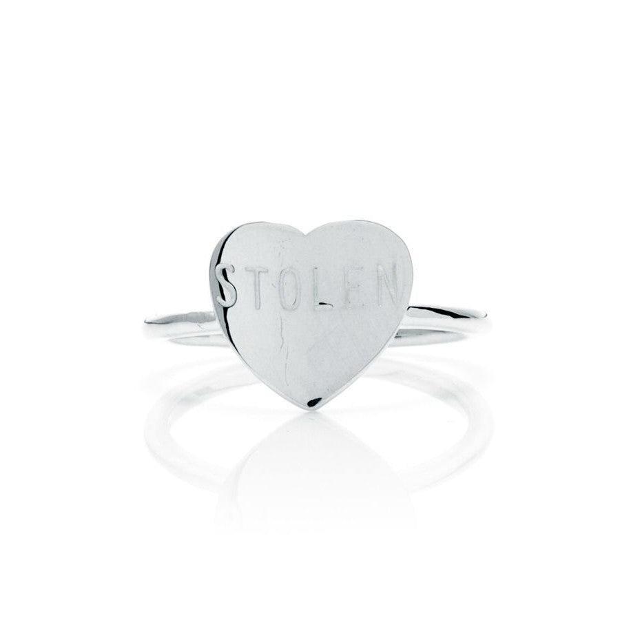 STOLEN GIRLFRIENDS CLUB STOLEN HEART RING - SILVER   The Stolen Girlfriends Club Stolen Heart Ring in Silver is perfectly petite ring, suspending a large finely curved heart engraved with the iconic "Stolen".  Crafted using high polish sterling silver, The Stolen Heart Ring is simple, feminine and great for stacking; wear alone or mix'n'match with other Stolen Girlfriends Club Rings!