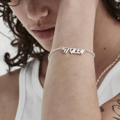 STOLEN GIRLFRIENDS CLUB BERATE BRACELET  The Stolen Girlfriends Club Berate Bracelet is a simple feminine bracelet perfect for daily wear. The Berate bracelet features a fine chain with 'Stolen' written in a connected futuristic font, finished with a classic clasp closure. Simple, modern and stylish, wear the Stolen Girlfriends Club Berate Bracelet daily or for your chosen occasion.