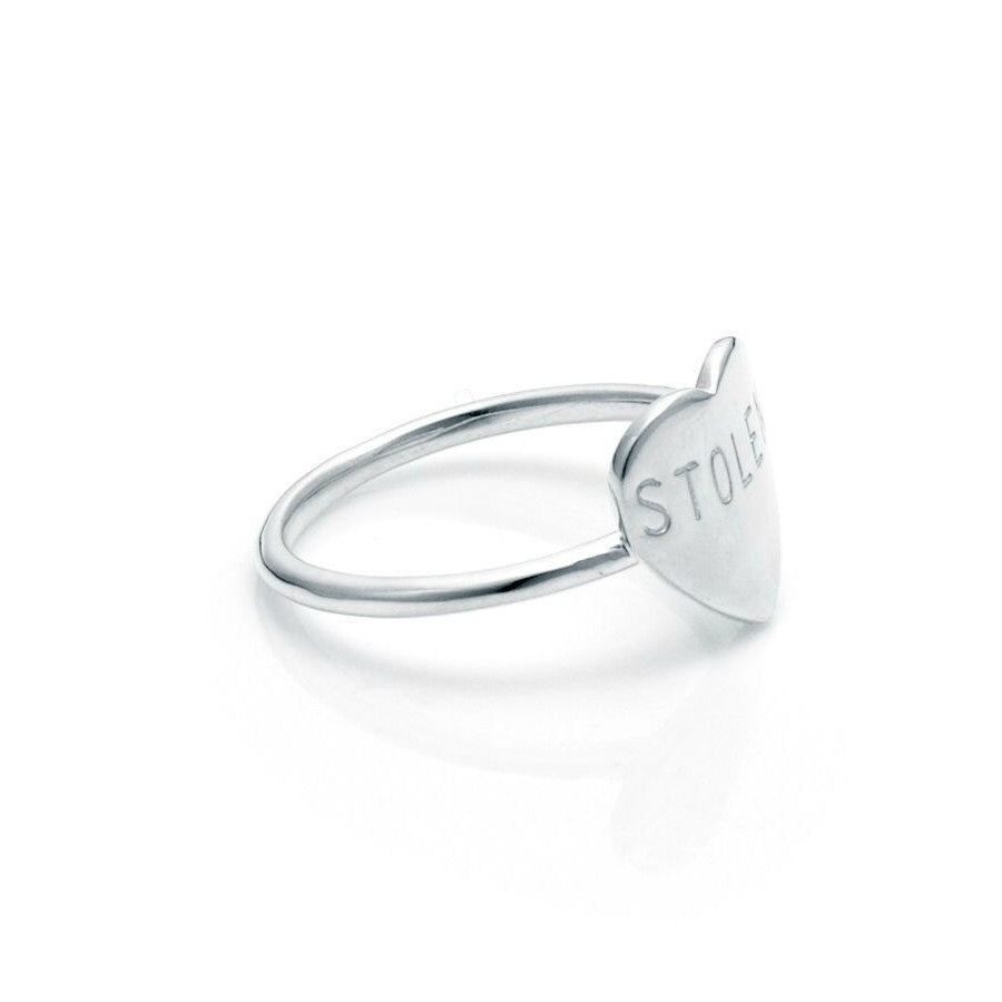 STOLEN GIRLFRIENDS CLUB STOLEN HEART RING - SILVER   The Stolen Girlfriends Club Stolen Heart Ring in Silver is perfectly petite ring, suspending a large finely curved heart engraved with the iconic "Stolen".  Crafted using high polish sterling silver, The Stolen Heart Ring is simple, feminine and great for stacking; wear alone or mix'n'match with other Stolen Girlfriends Club Rings!