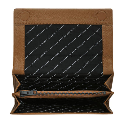STATUS ANXIETY NEVERMIND WALLET  The Status Anxiety Some Type Of Love Wallet is a simple yet elegant wallet, simple enough for every day use.  This wallet features a single internal zipper pocket, convenient magnetic snap-closure, signature 'Status Anxiety' stamping at the front, and black internal hardware, finished with eight internal card slots 