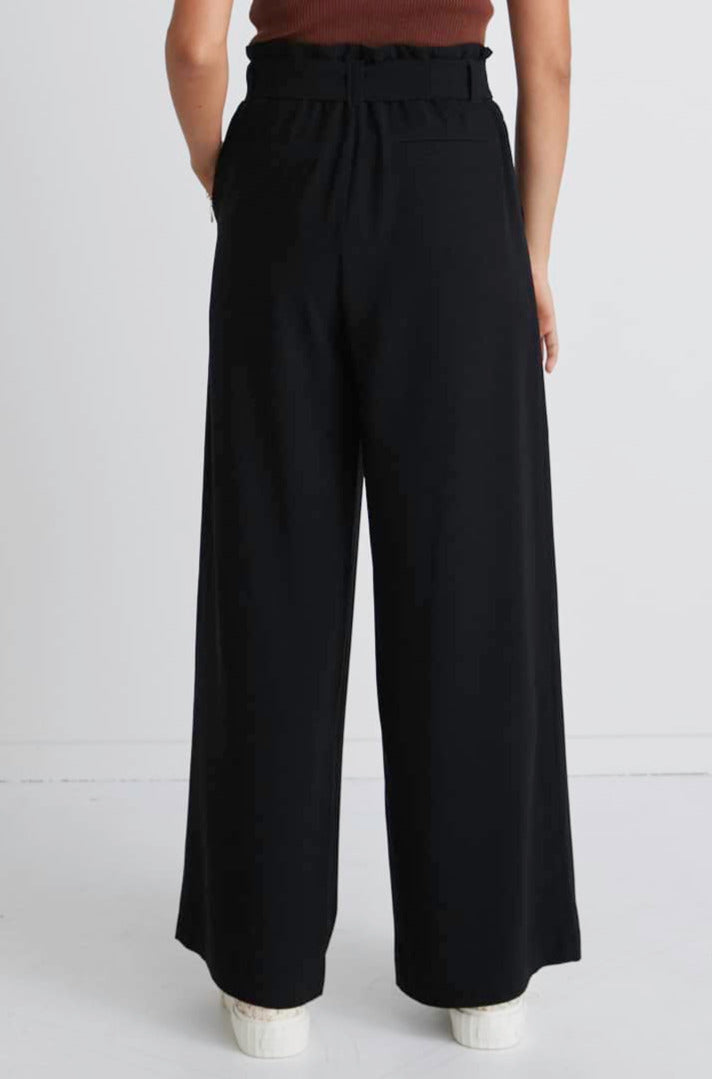 Stories Be Told Sydney Crepe Tie Belt Pant - Black  The Stories Be Told Sydney Pant is available in classic black. It features a paper bag waist, a belt to tie, pockets and is a wide leg style This pant is a fantastic wardrobe staple to take you from one season to the next.  Team back with your favourite tops or knits and layer with jackets or coats in the cooler months. 