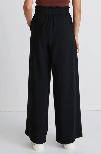 Stories Be Told Sydney Crepe Tie Belt Pant - Black  The Stories Be Told Sydney Pant is available in classic black. It features a paper bag waist, a belt to tie, pockets and is a wide leg style This pant is a fantastic wardrobe staple to take you from one season to the next.  Team back with your favourite tops or knits and layer with jackets or coats in the cooler months. 