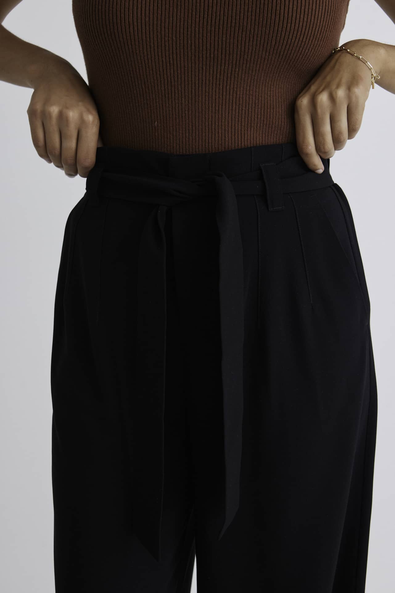 Stories Be Told Sydney Crepe Tie Belt Pant - Black  The Stories Be Told Sydney Pant is available in classic black. It features a paper bag waist, a belt to tie, pockets and is a wide leg style This pant is a fantastic wardrobe staple to take you from one season to the next.  Team back with your favourite tops or knits and layer with jackets or coats in the cooler months. 