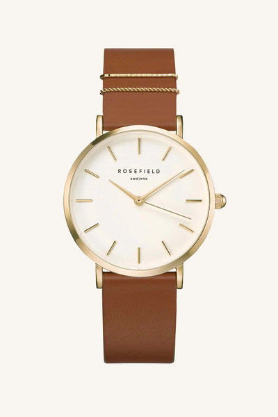 ROSEFIELD WEST VILLAGE WATCH  The Rosefield West Village Watch is a beautiful feminine watch sporting unique metal plated rings for added individuality and style, this watch effortlessly compliments any outfit weather it be causal or formal!  The West Village Watch features a subtle pearl sheen on the face, has a raw-cut unstitched leather strap, and is perfect for daily or occasion wear.